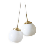 A pair of white opaline and brass suspensions.