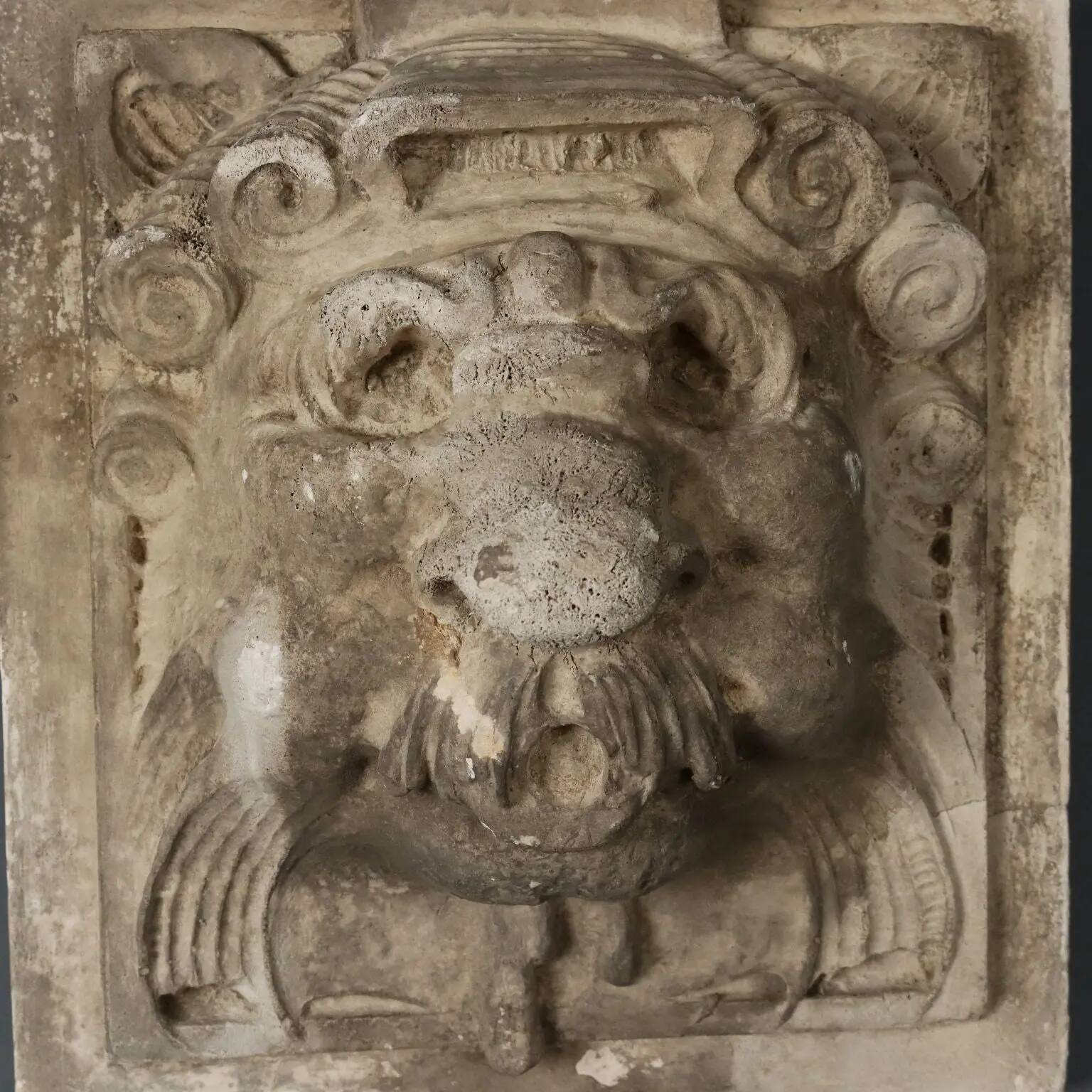 Old plaster tile with a fierce mask decoration, Italy, 19th century.