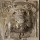 Old plaster tile with a fierce mask decoration, Italy, 19th century.