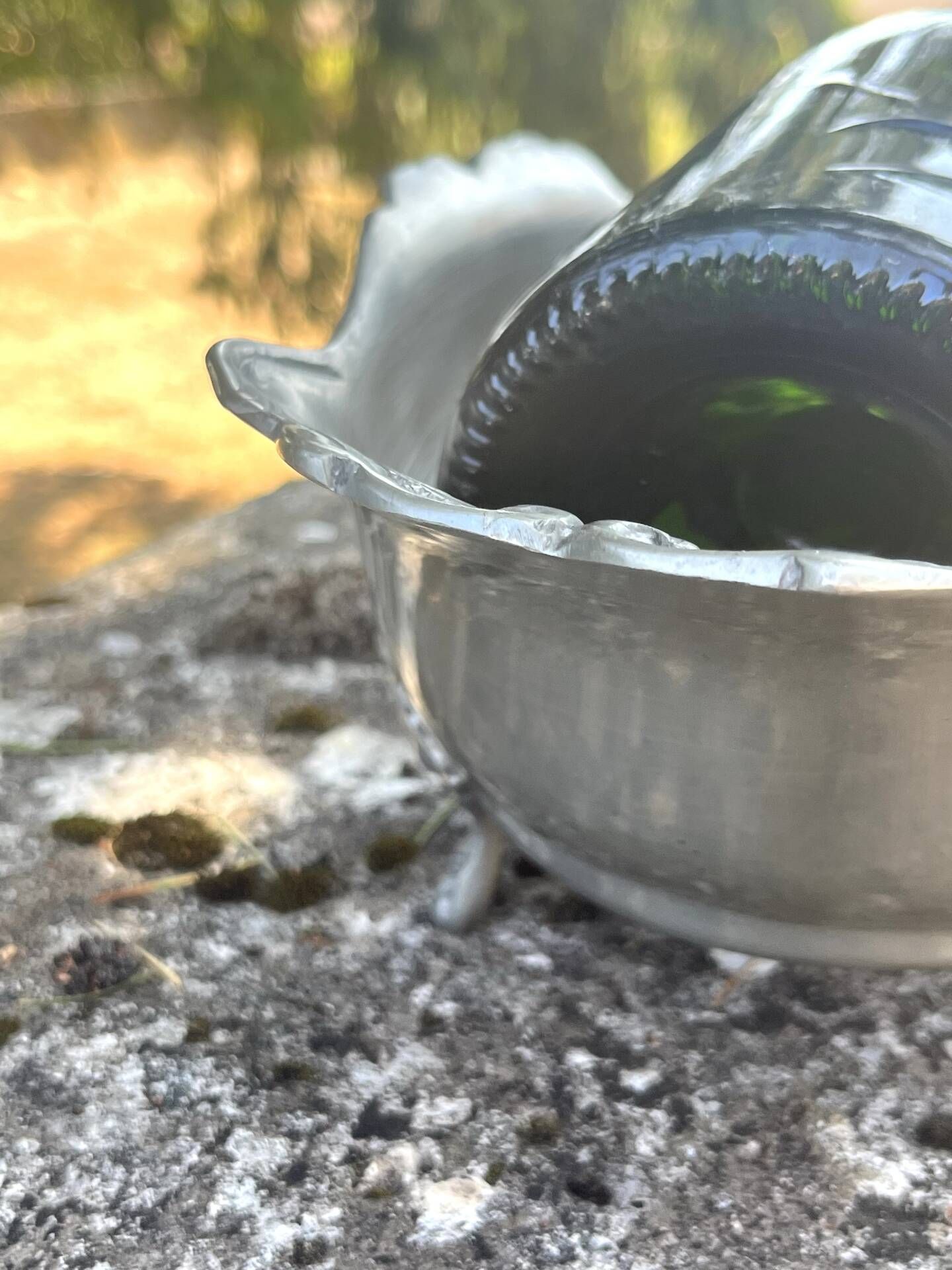 Footed pewter champagne cooler on claw feet with floral relief