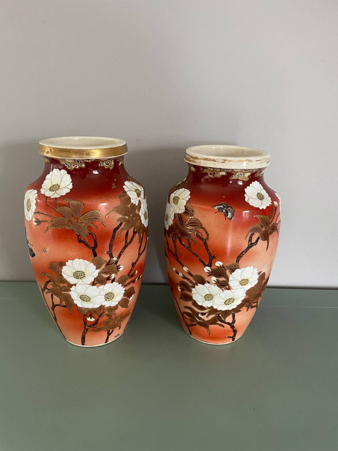 Pair of antique vases with butterfly and flower motif.