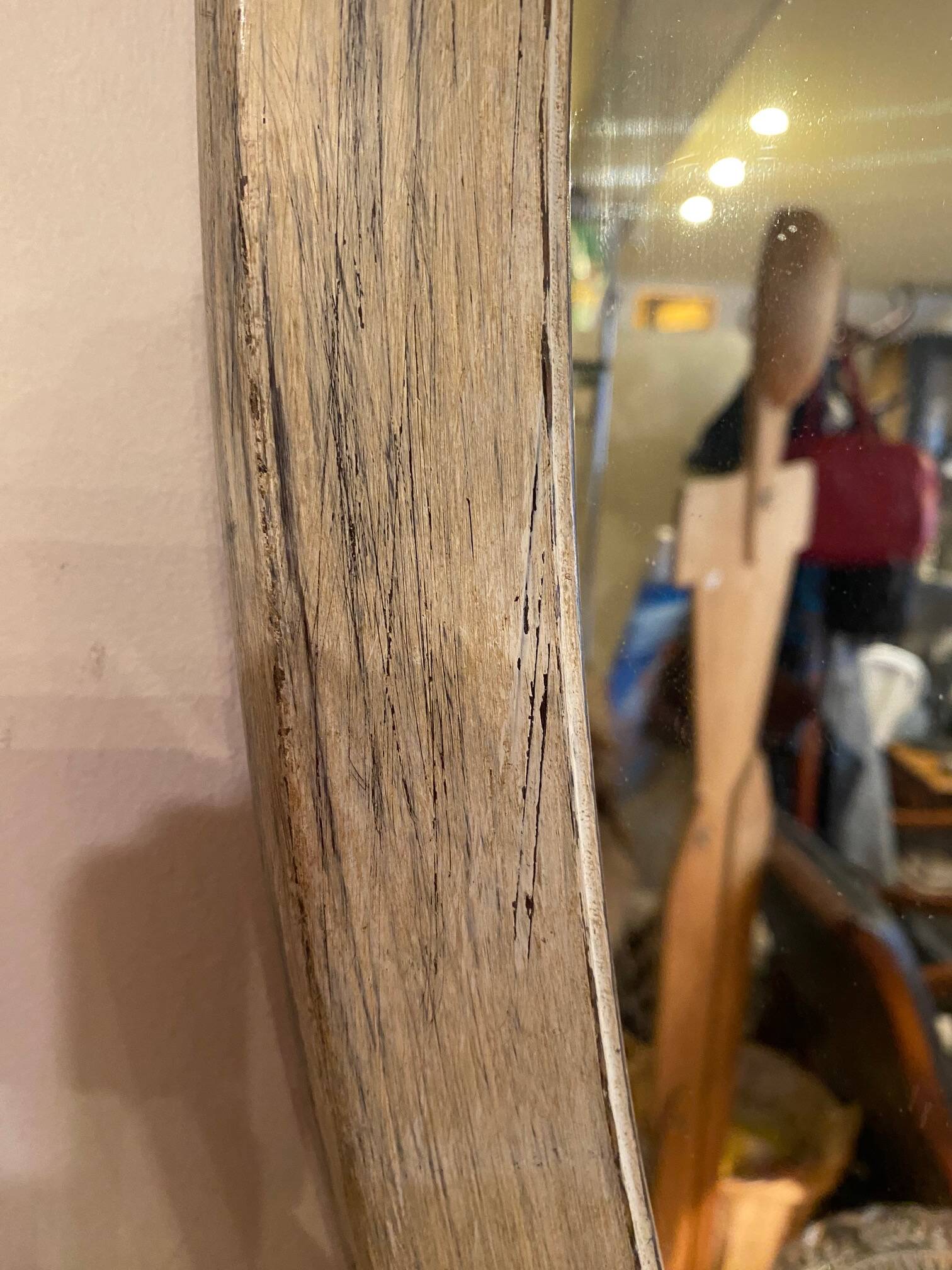 Large old oval mirror with beige patina wooden frame early 20th century