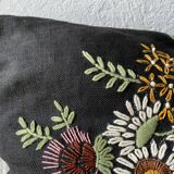 Embroidered black linen cushion
