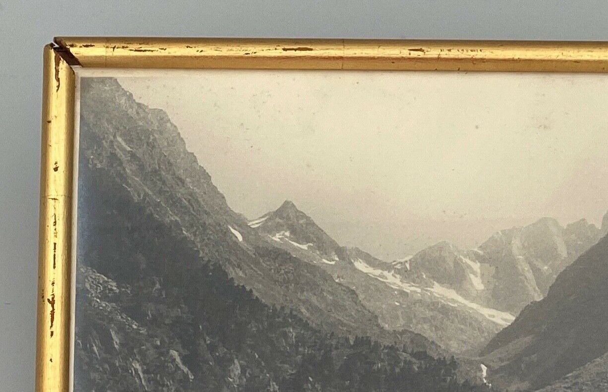 Photo in black and white mountain lake in golden frame