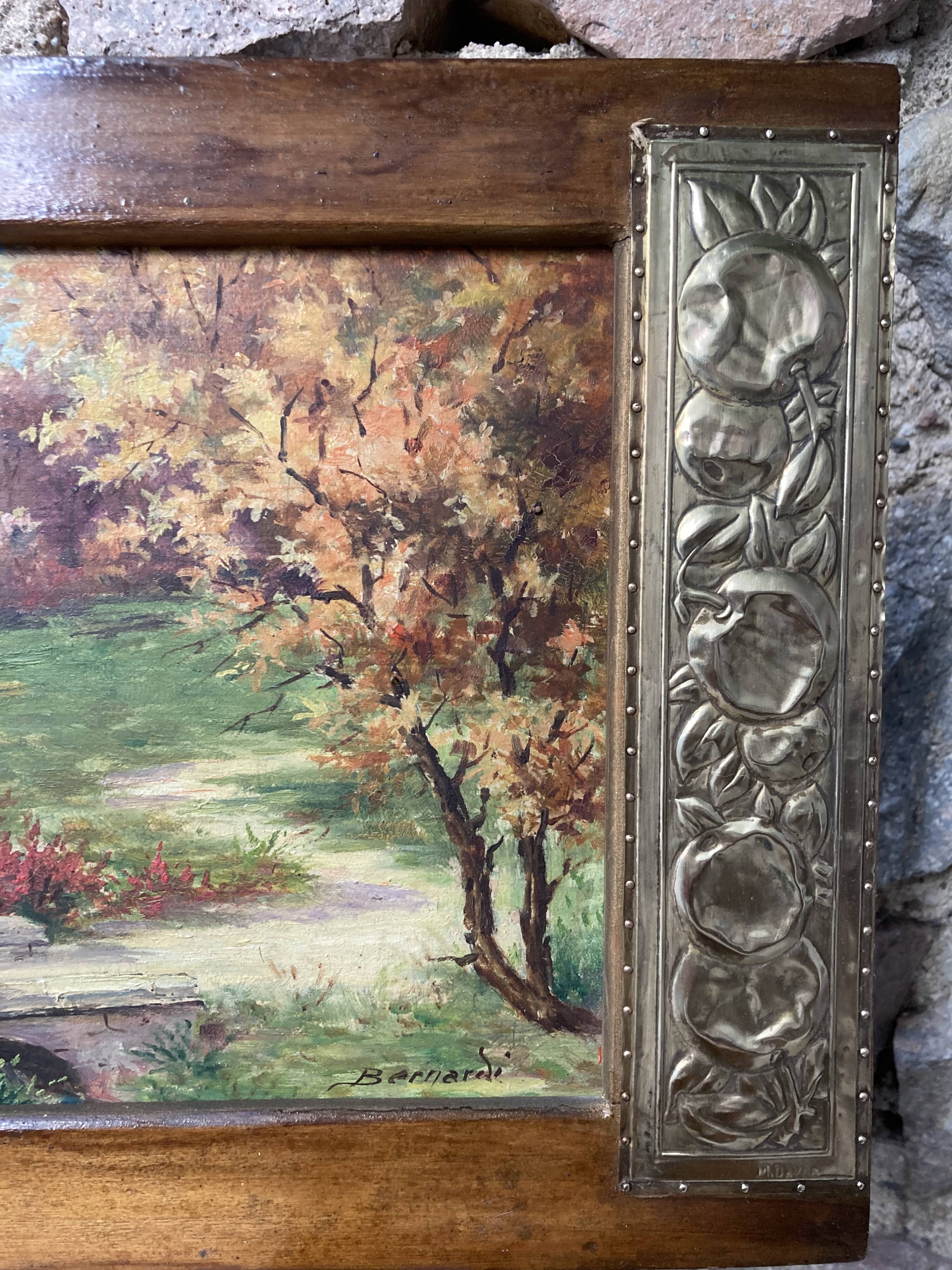 Pair of Art Deco wood and embossed metal landscape frames