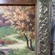 Pair of Art Deco wood and embossed metal landscape frames