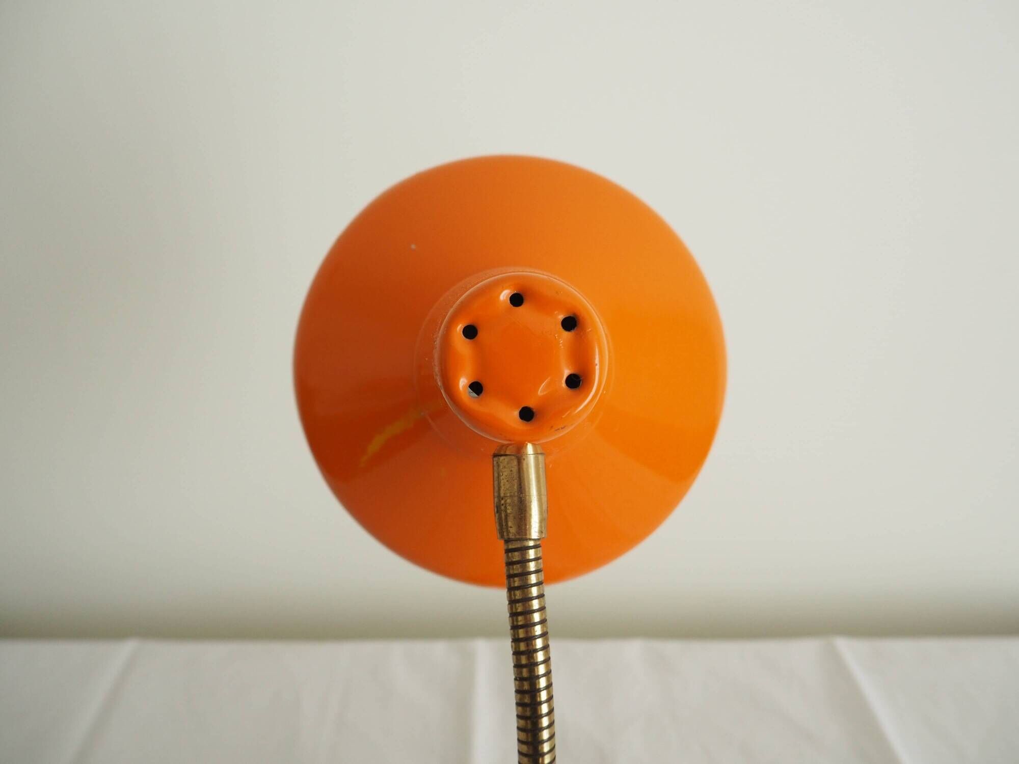 Orange colored metal desk lamp from the 1960s-1970s