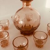 Service with vintage liqueur in pink rosaline glass