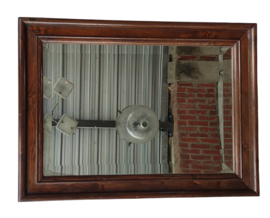 Old beveled mirror with wooden frame