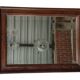 Old bevelled mirror with a wooden frame.