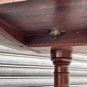 19th-century solid mahogany table with a tilting top and brass mechanism.