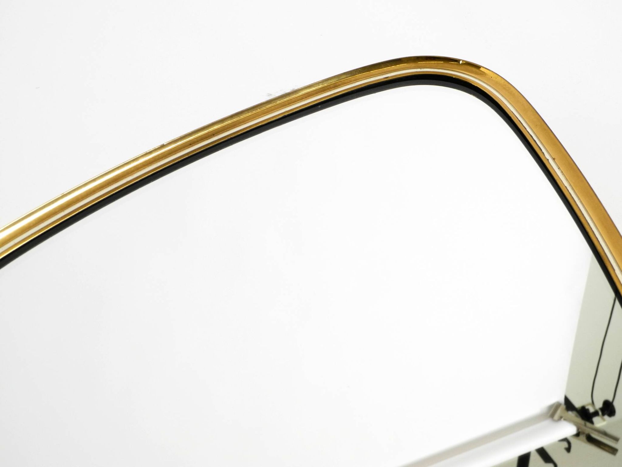 Heavy mid-century brass kidney-shaped wall mirror from Münchner Zierspiegel