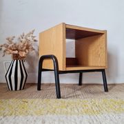 Bedside table - small wooden piece of furniture with a tubular metal base.