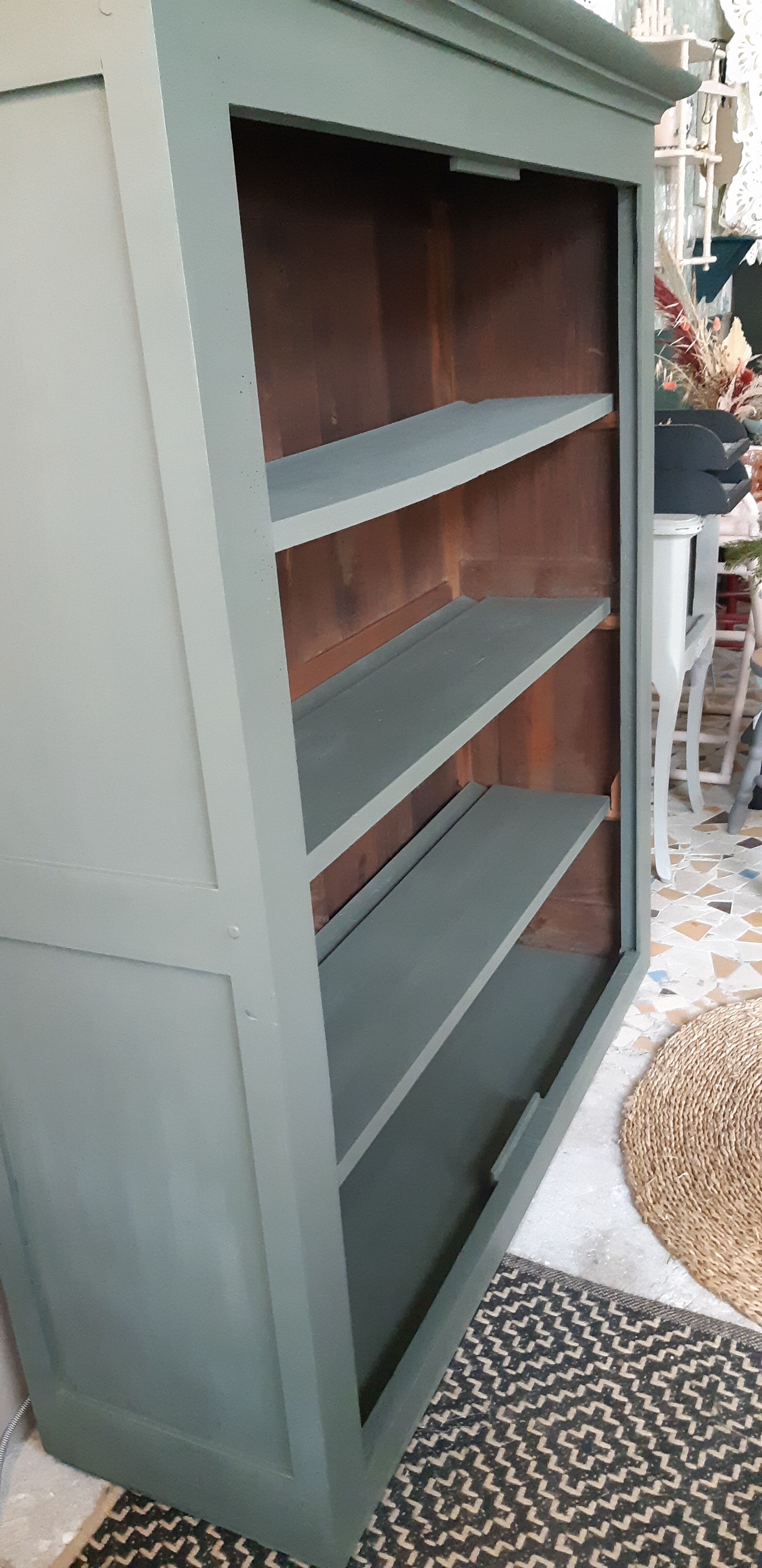 Wood and khaki green bookcase