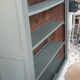 Wood and khaki green bookcase