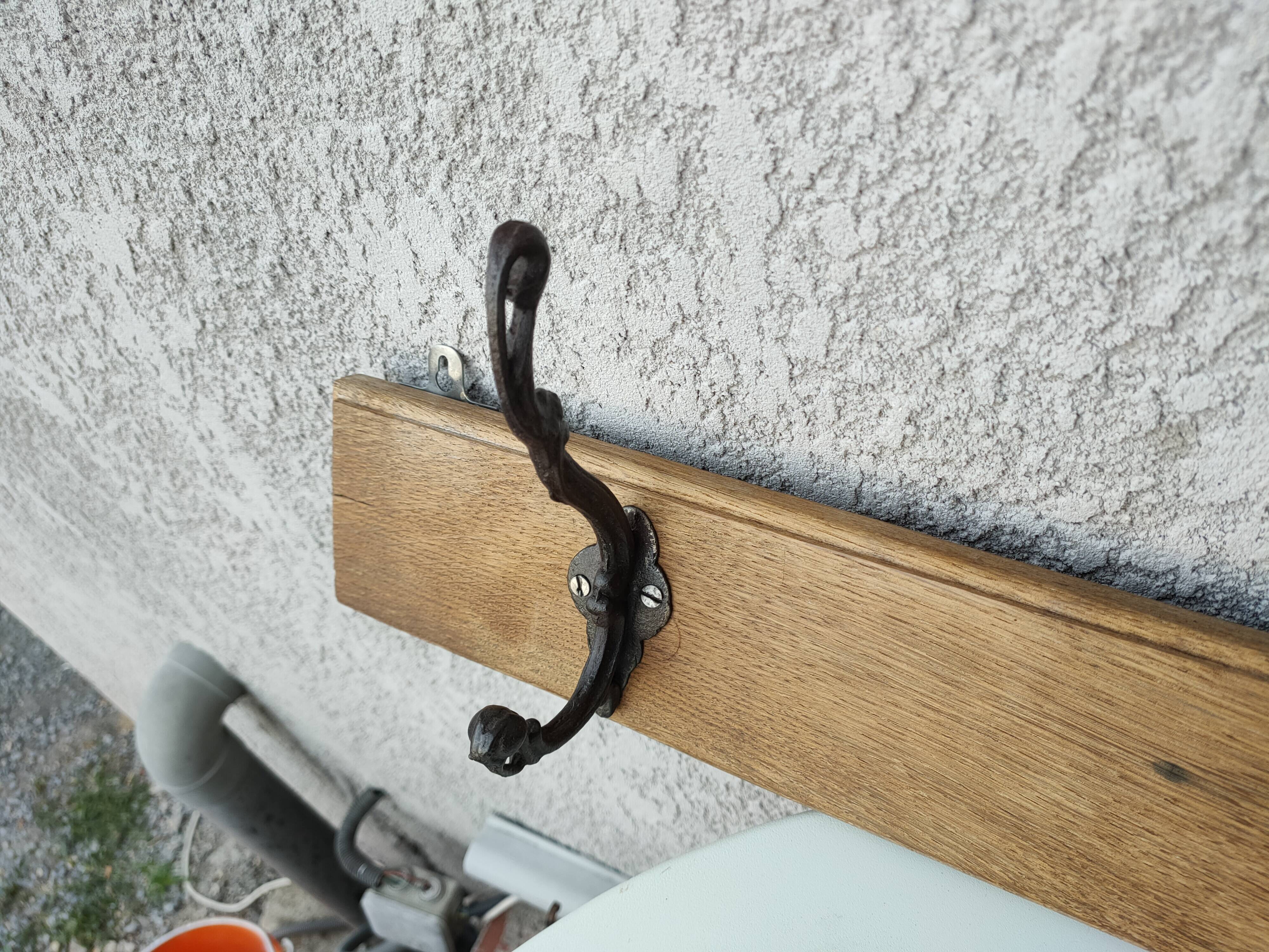 antique coat rack with 3 cast iron hooks