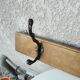 antique coat rack with 3 cast iron hooks