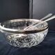 Salad bowl and serving cutlery in glass and silver metal