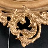 Large oval mirror in gilded wood