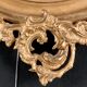 Grand miroir ovale en bois doré