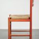Nice red vintage wooden chair from the 1970s with a woven wicker seat