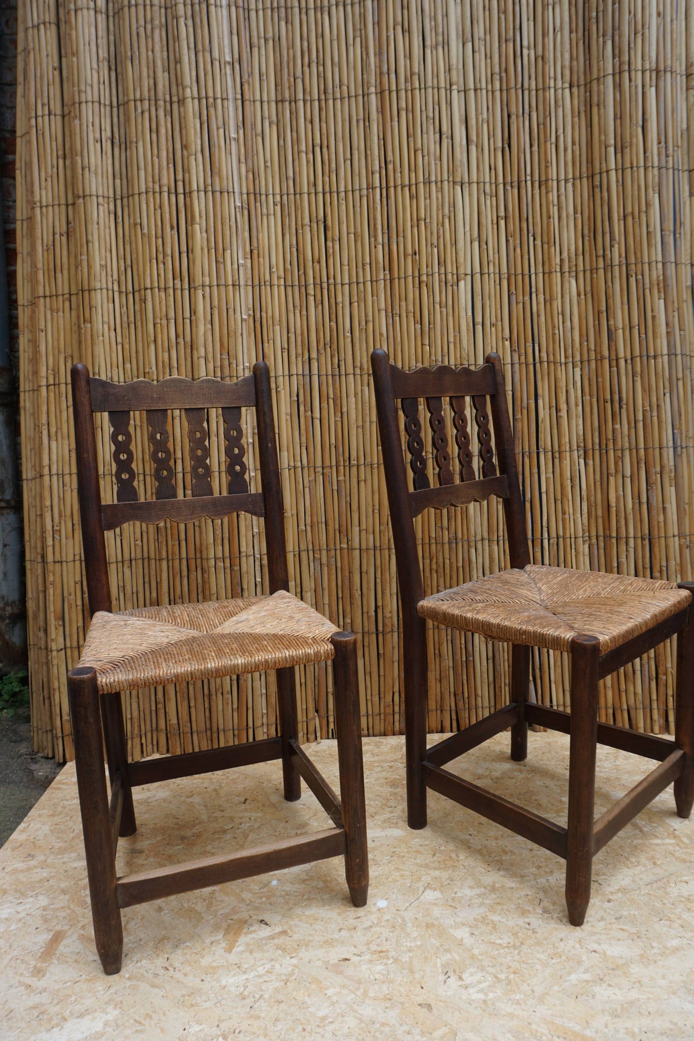 Pair of antique straw-seated farm chairs