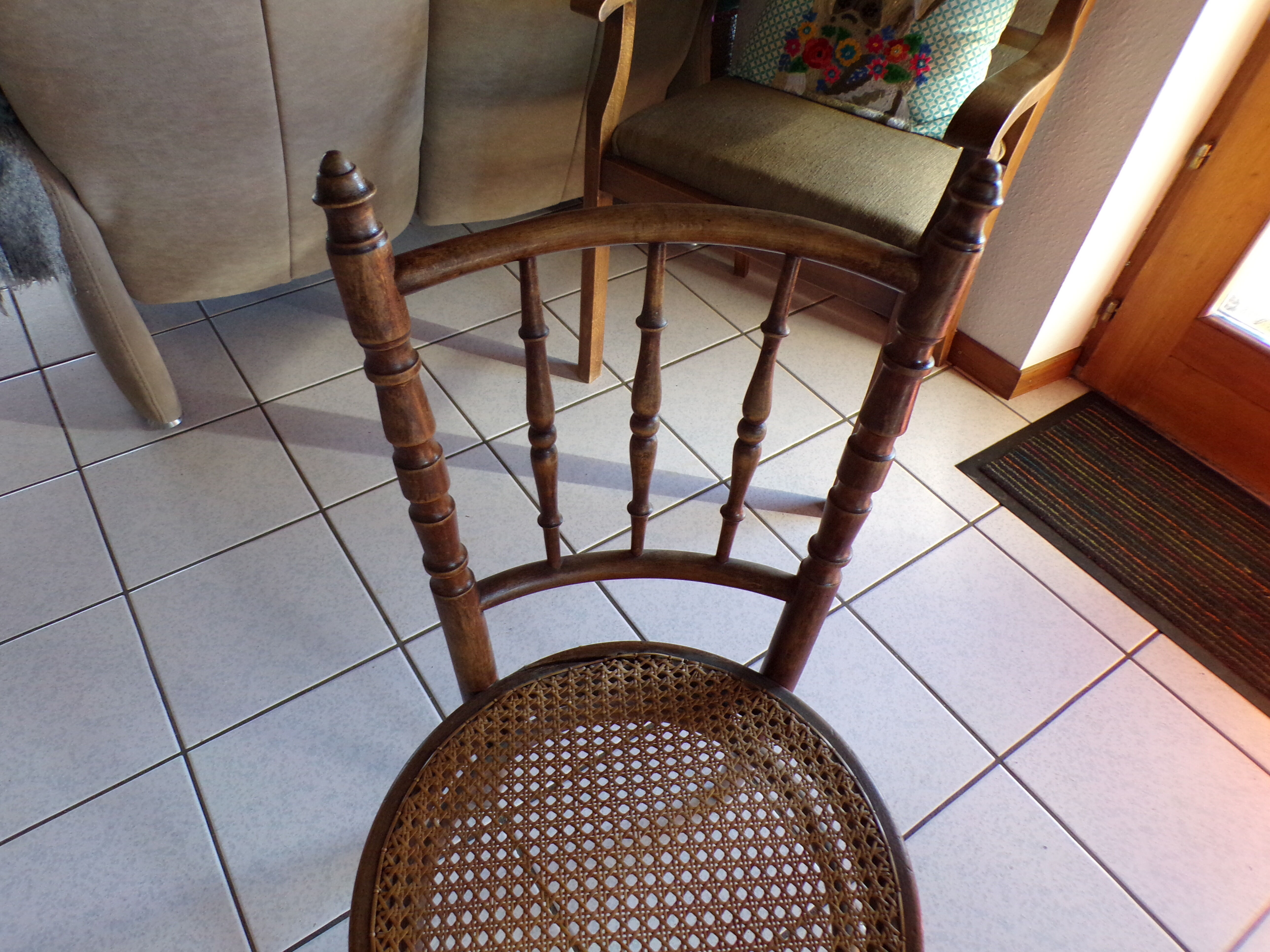 Curved wooden chair, turned and seated in cannage