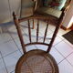 Curved wooden chair, turned and seated in cannage