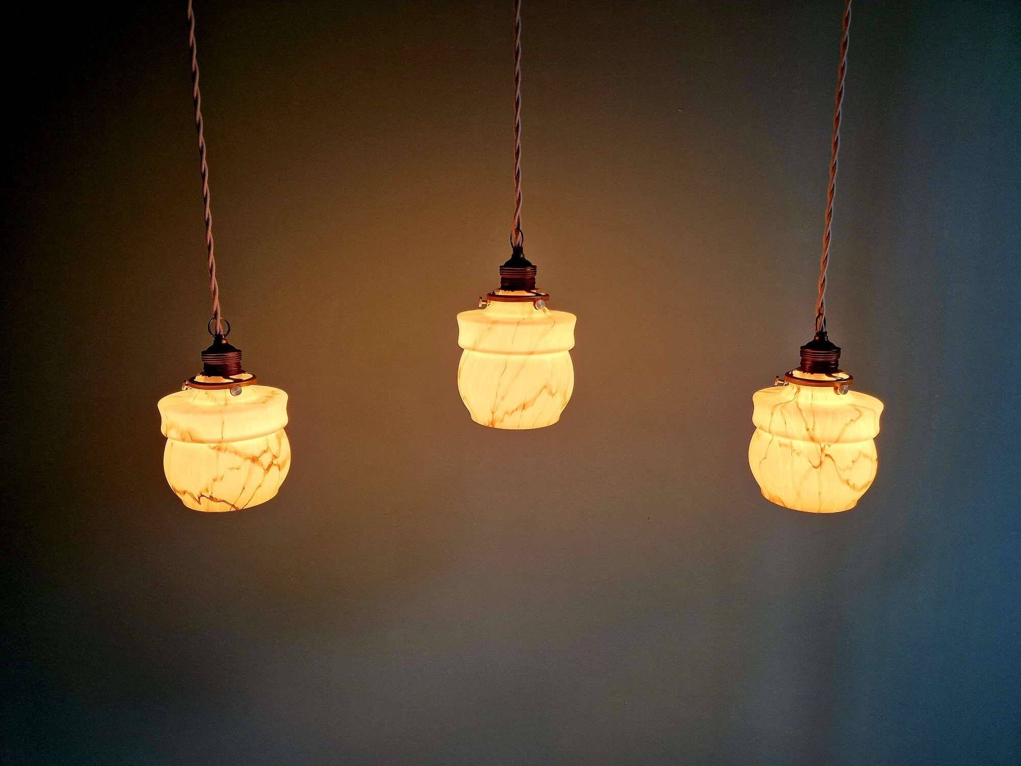 Art Deco trio of suspensions in opaline and marbled ouraline, Scailmont, 1920-30.