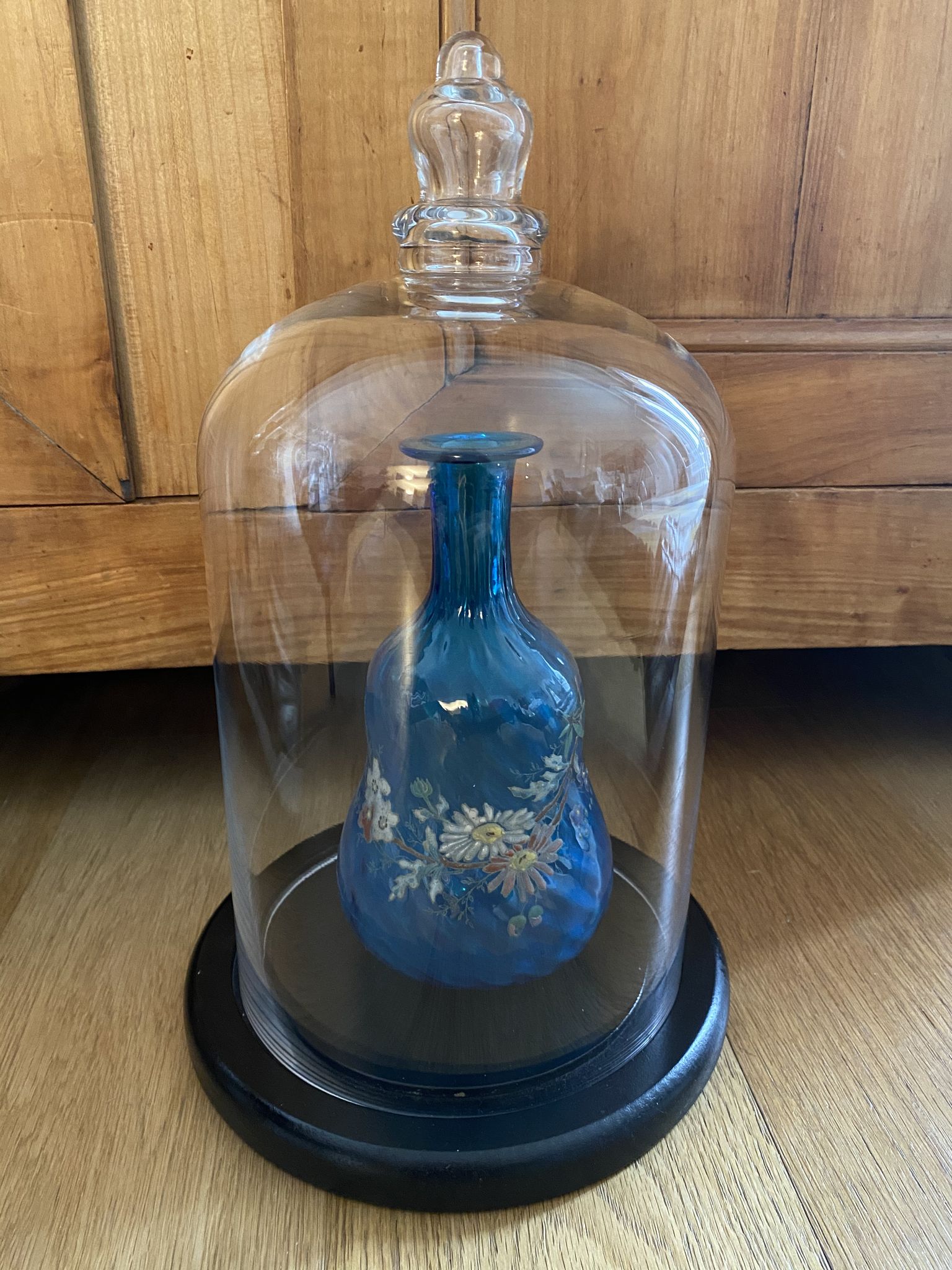 Large old glass bell and its wooden base