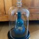 Large old glass bell and its wooden base