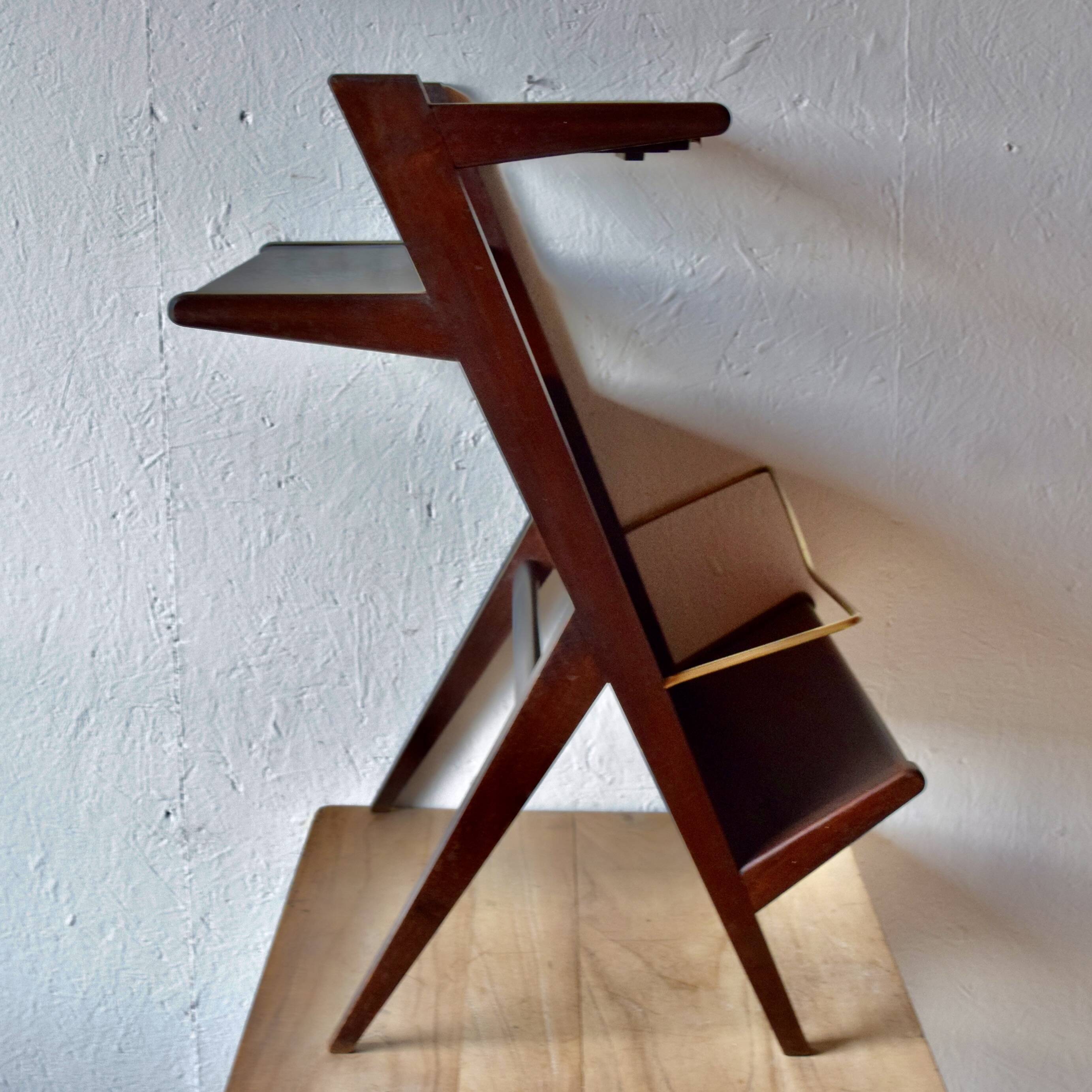 Old Scandinavian style magazine rack in dark wood with integrated brass ashtray