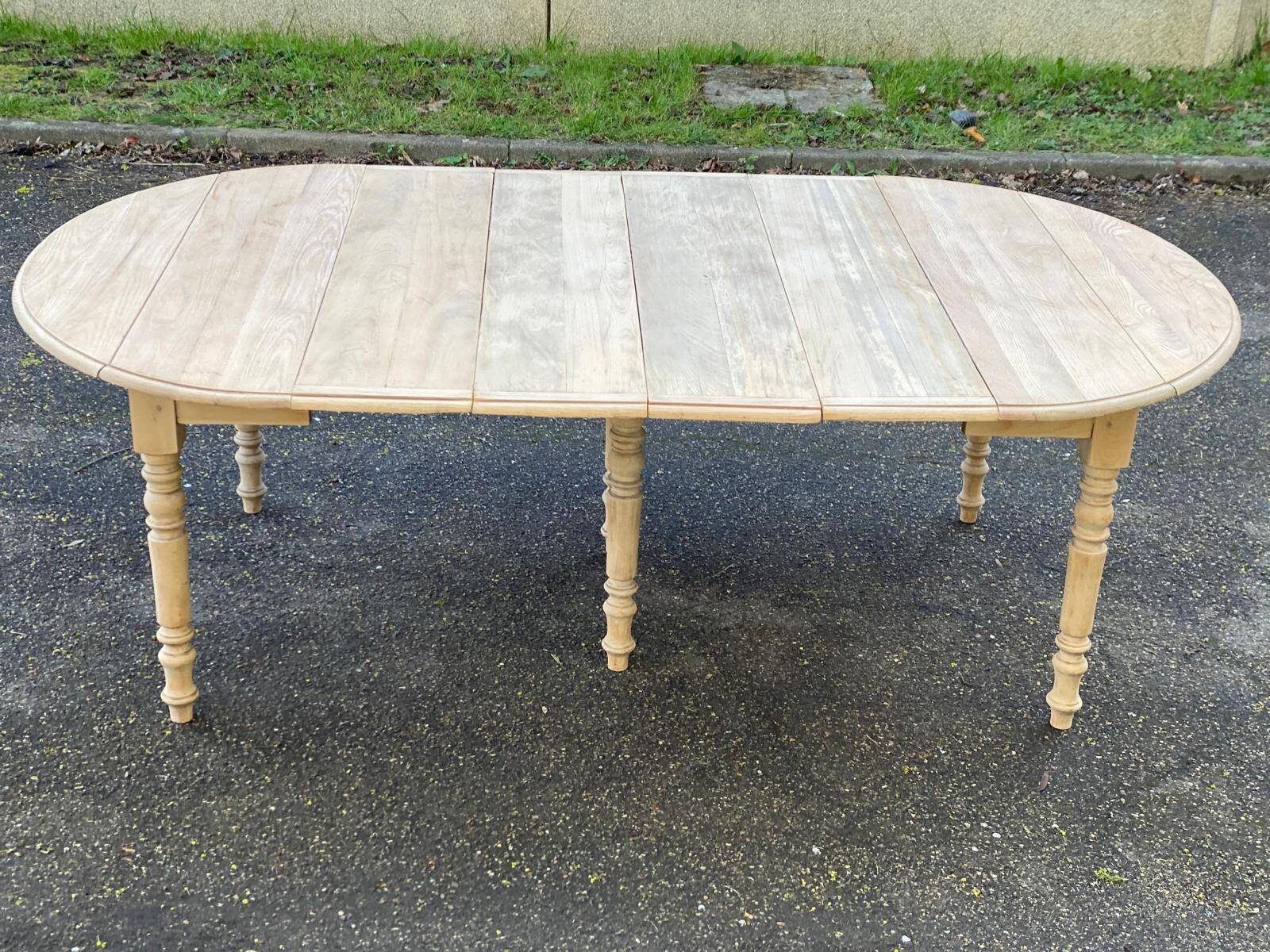 Renovated Louis Philippe round extendable dining table with 4 leaves.