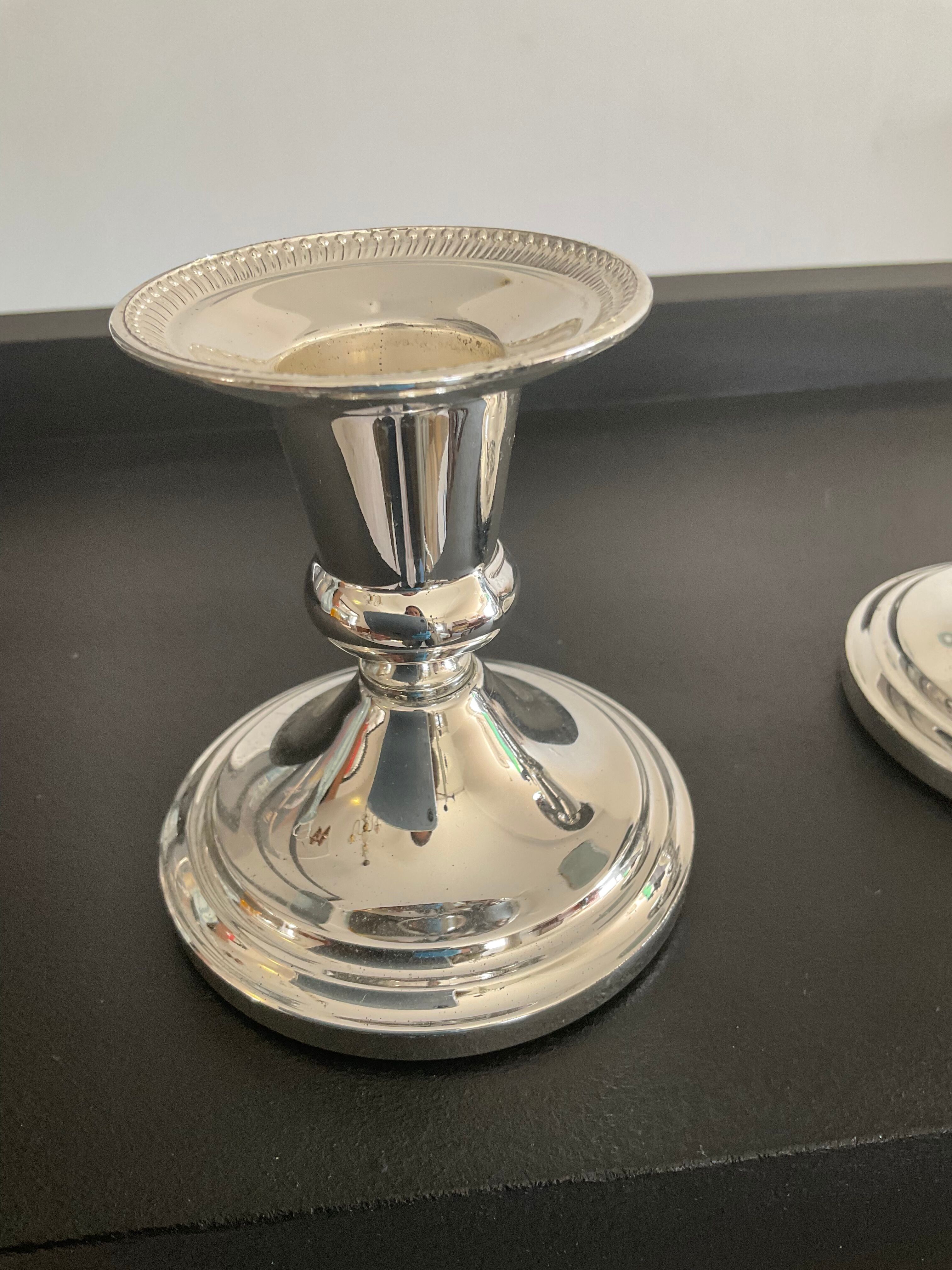 Pair of vintage candle holders in silver metal