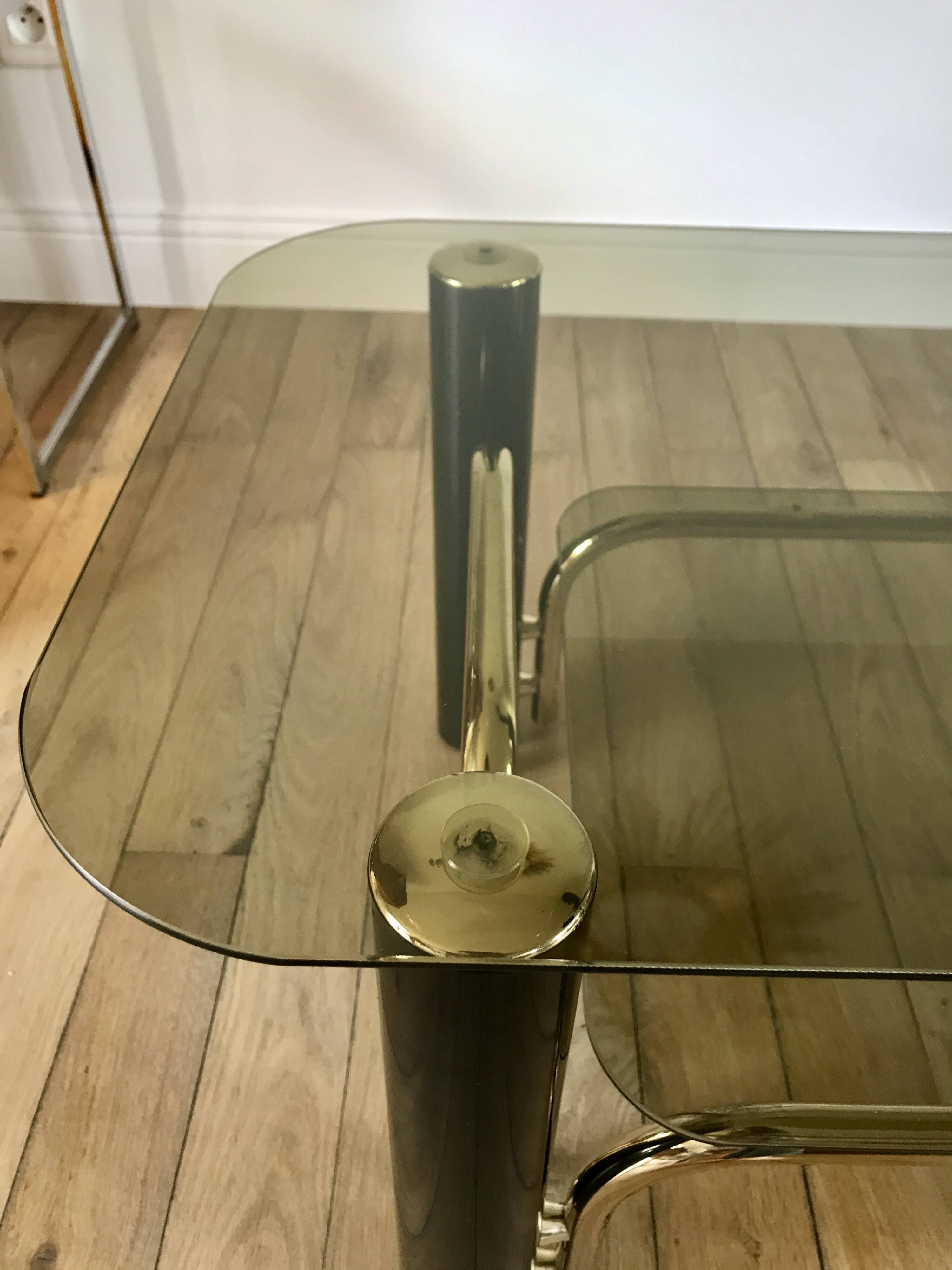 coffee table in smoked glass and black and gold metal from the 70s