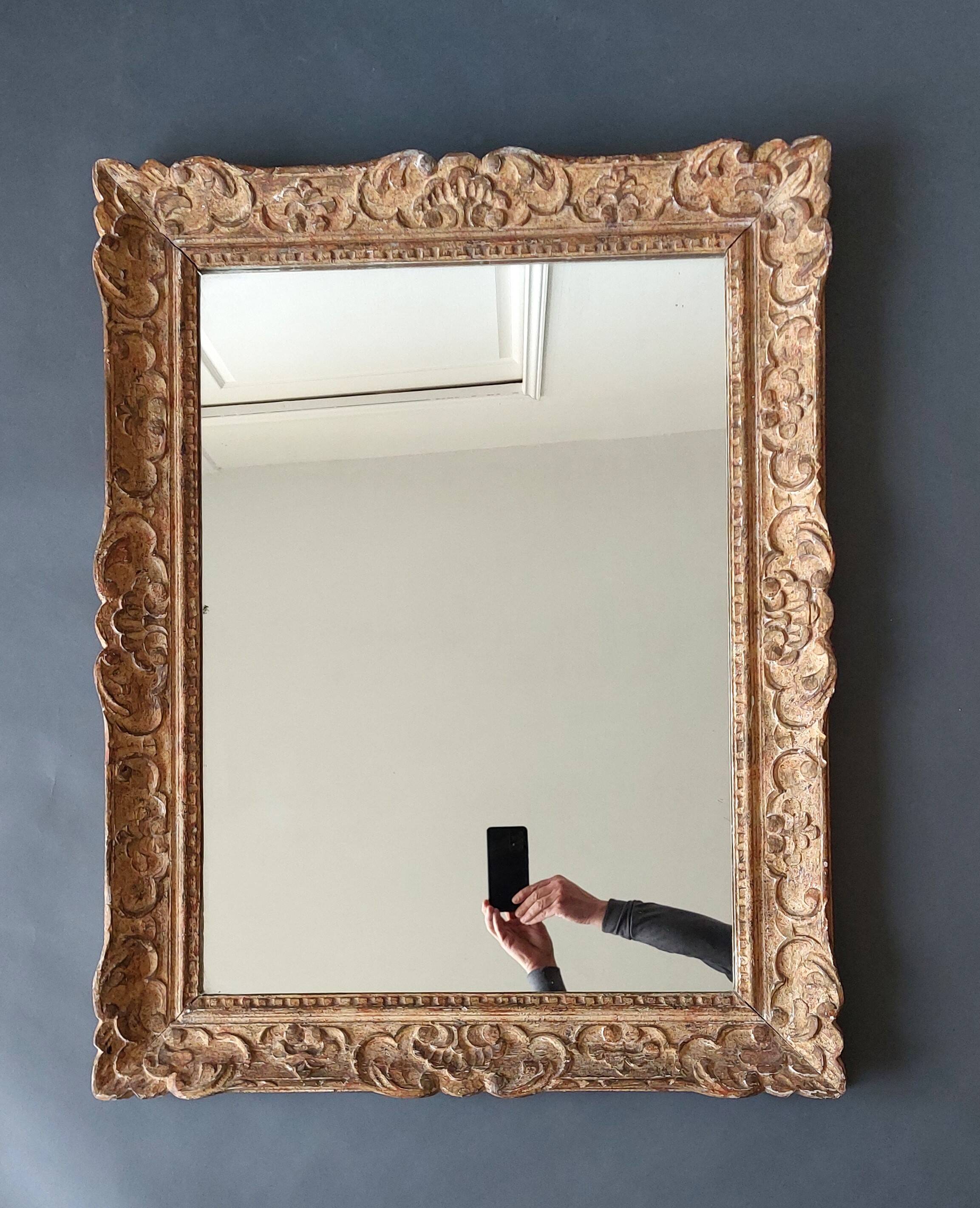 Large Montparnasse rocaille style frame in carved wood mounted in mirror.