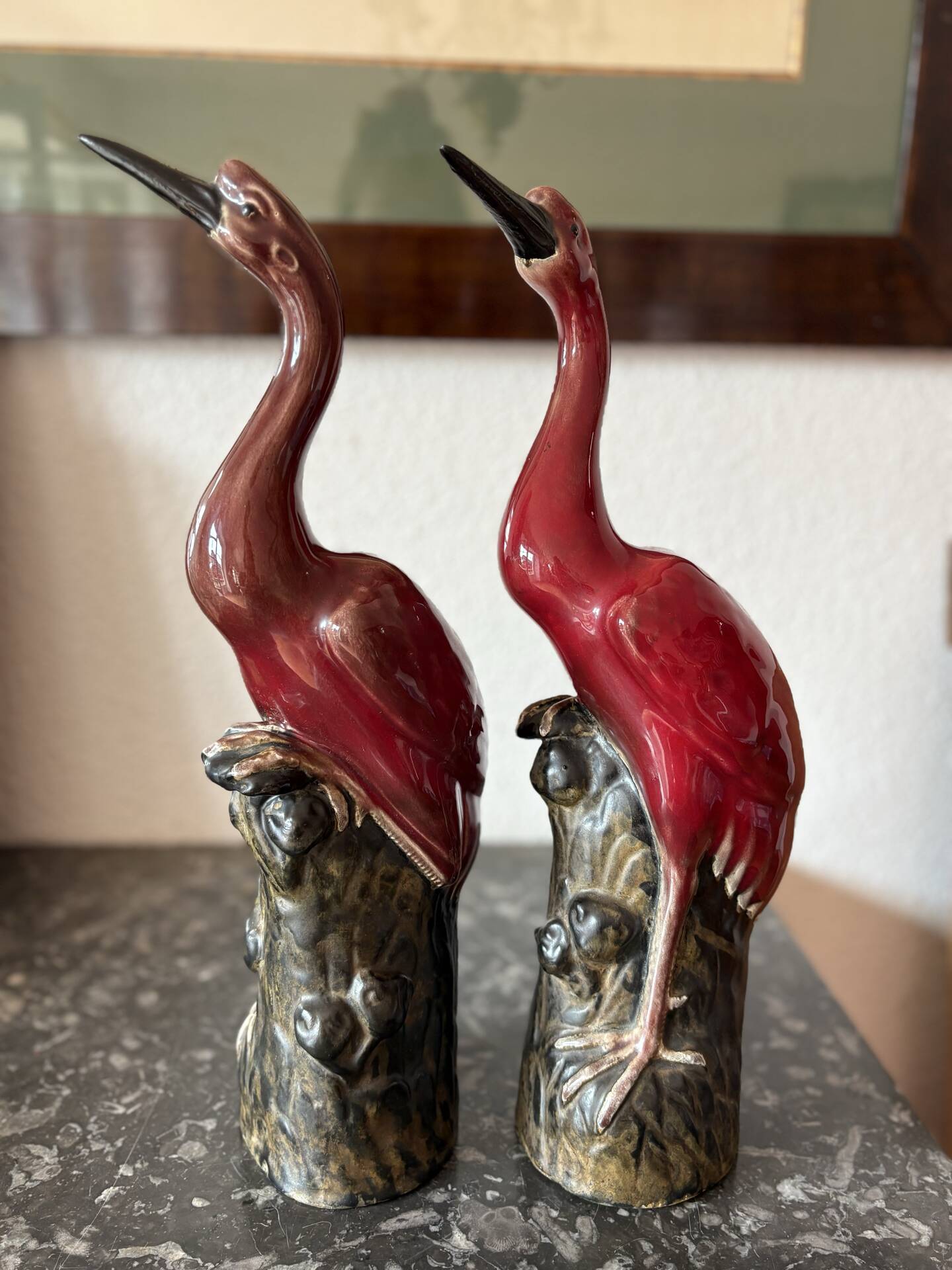 Pair of ceramic red glazed wading bird (crane) figurines.
