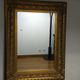 Mirror with large molded frame in gilded plaster with gold leaf