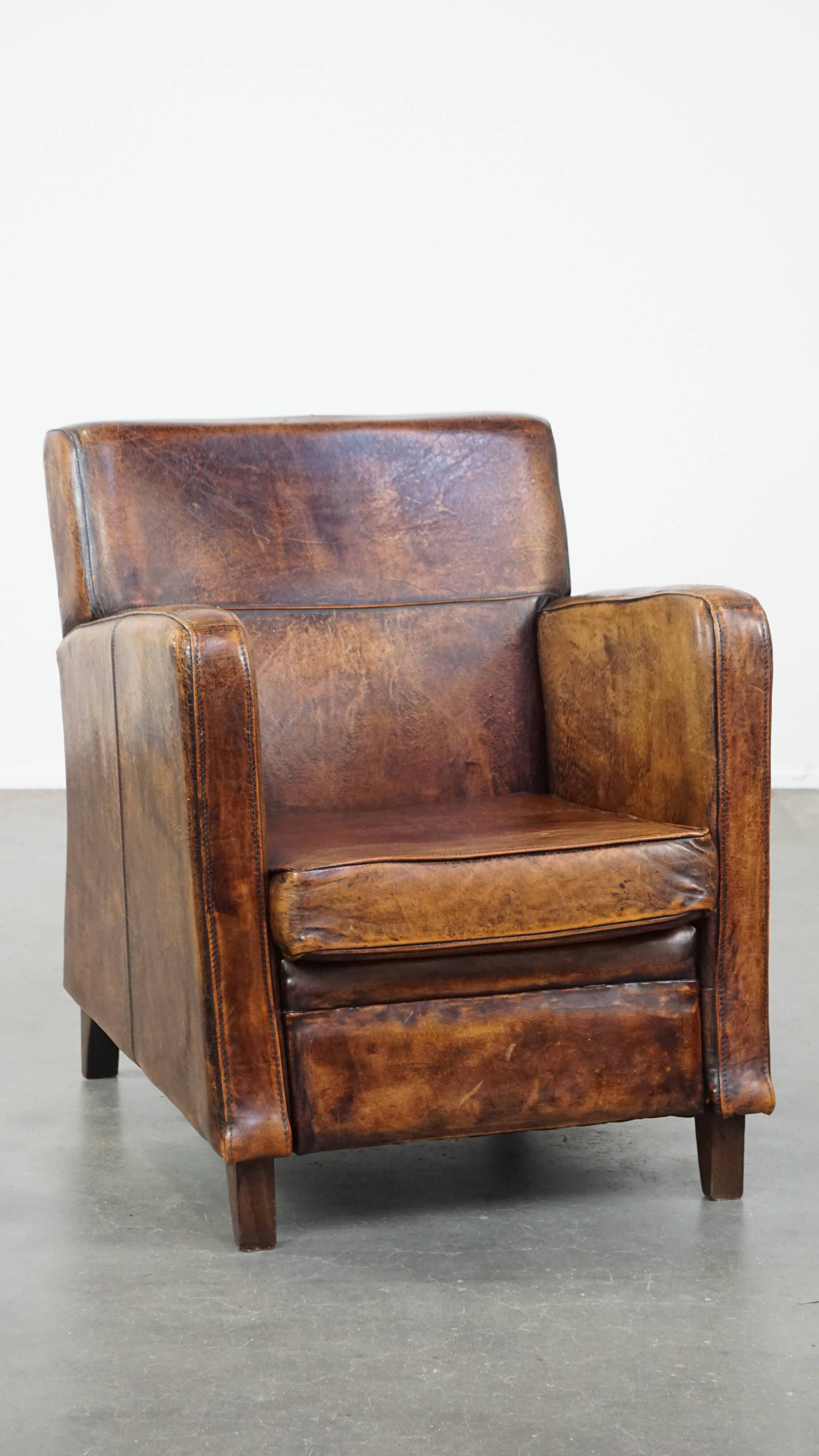 Dark brown design armchair made of sheepskin leather