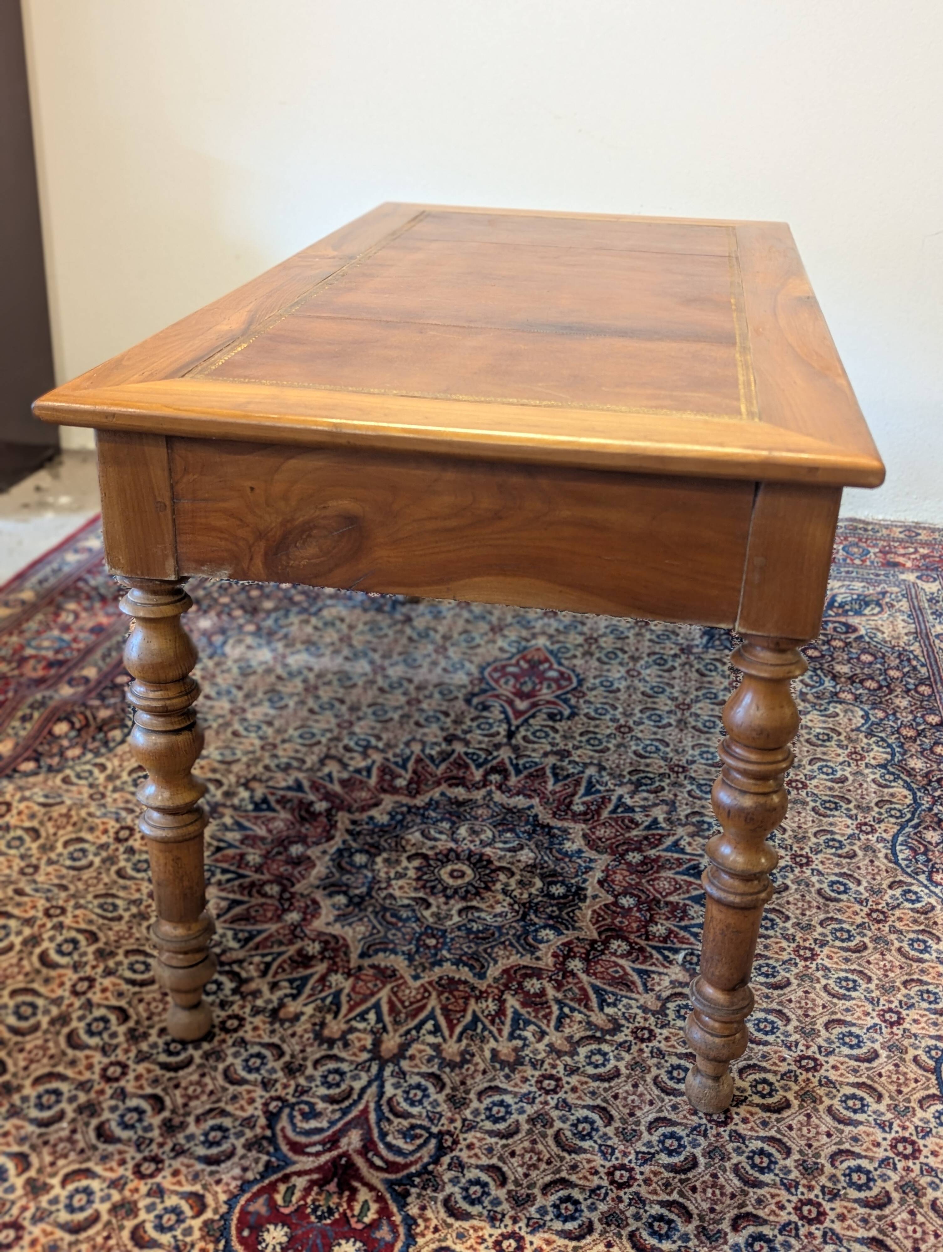 Cherry wood desk with a leather top.