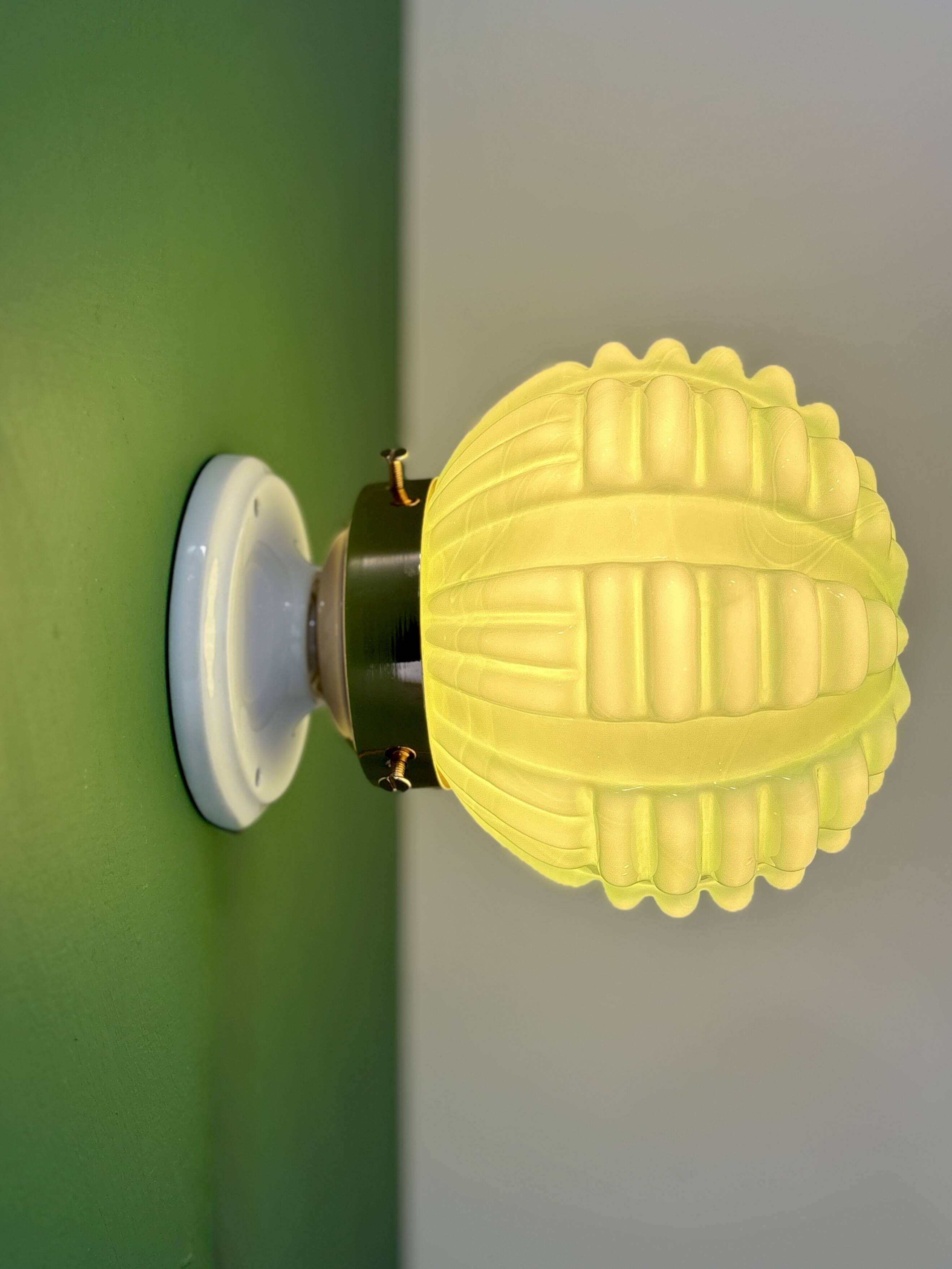 Vintage Art Deco globe wall light in pale green opaline.