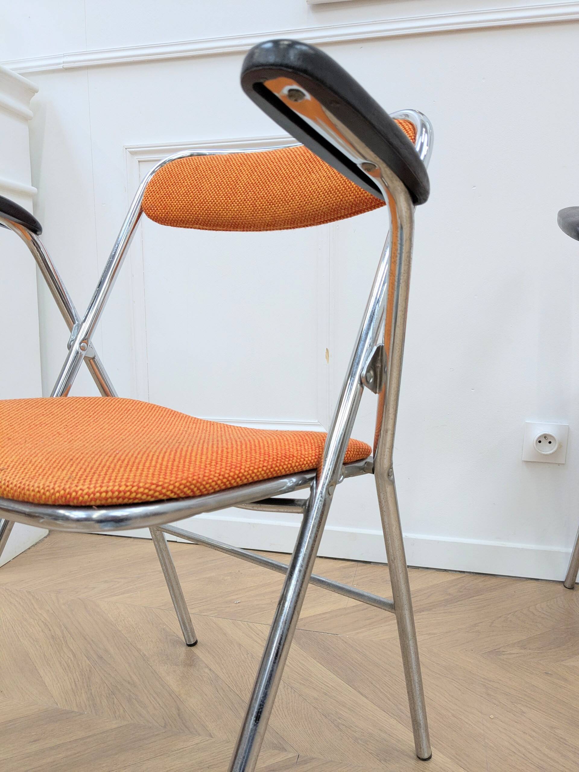 6 orange folding chairs