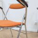 6 orange folding chairs