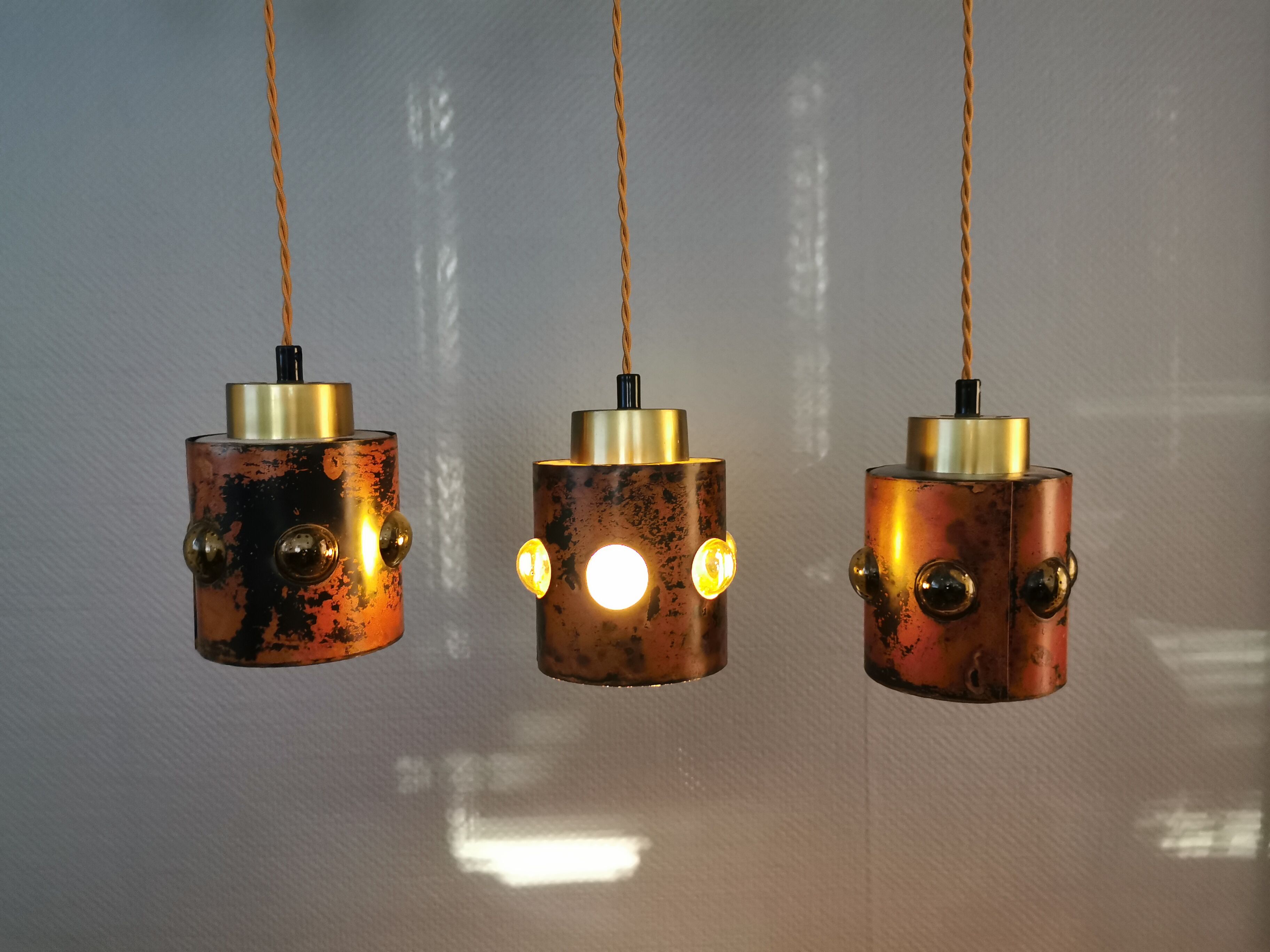 3 lamps made of copper, brass and glass.