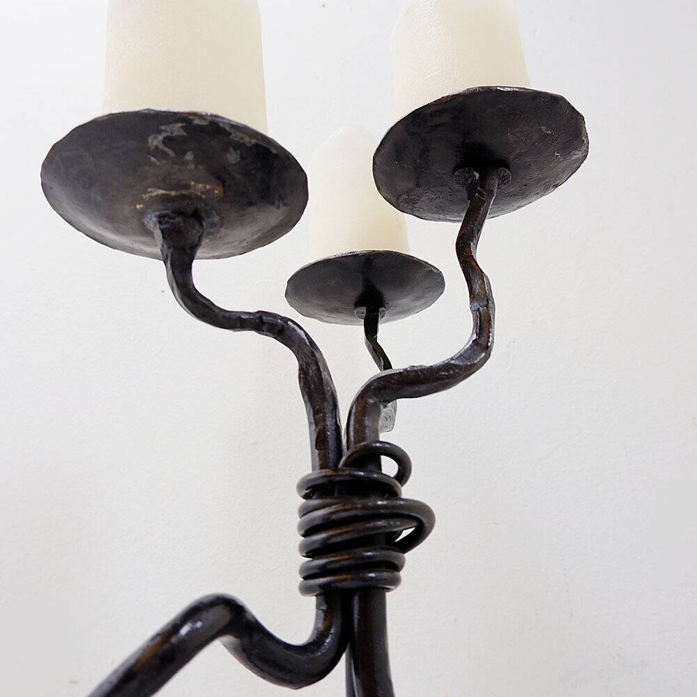 Large wrought iron candelabrum with an abstract design and three candle holders.