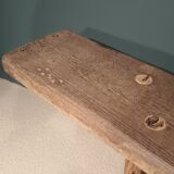 Old rough bench made of solid wood