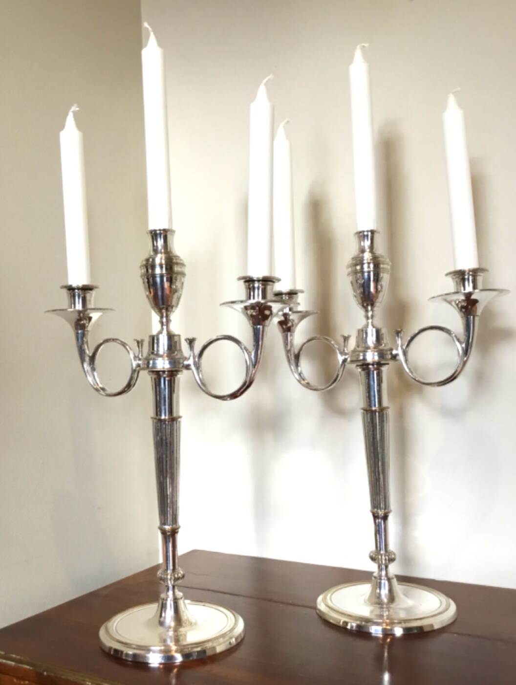 Pair of silver-plated metal candelabra decorated with hunting horns