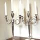 Pair of silver-plated metal candelabra decorated with hunting horns