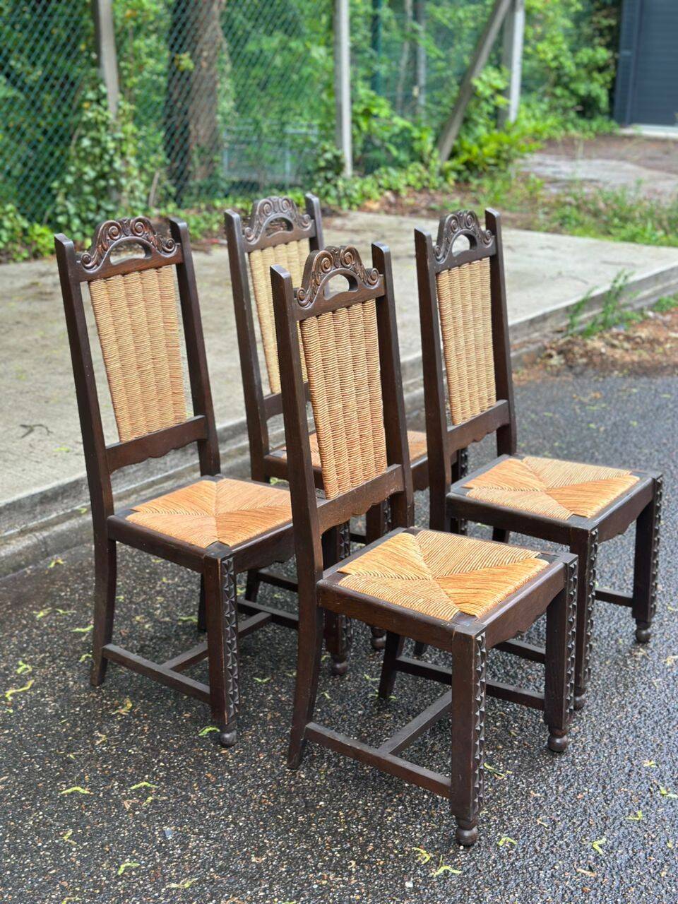 4 Basque solid wood dining chairs with carved straw seats.