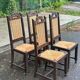 4 Basque solid wood dining chairs with carved straw seats.